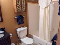 Upstairs bathroom with a standard tub/shower.