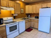 Kitchen with a refrigerator, stove, and dishwasher.