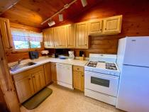 Kitchen with a standard refrigerator, stove, and dishwasher.