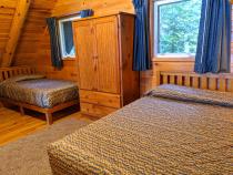 Loft bedroom with a queen and twin bed.