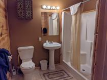 Main floor bathroom with a wide door and easy access shower and sink.