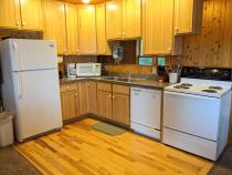Kitchen with a refrigerator, stove, and dishwasher.