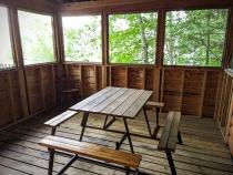 Screen porch with a picnic table.