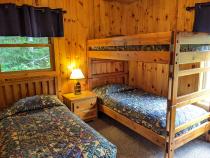 Upstairs bedroom with a twin and set of twin bunk beds.